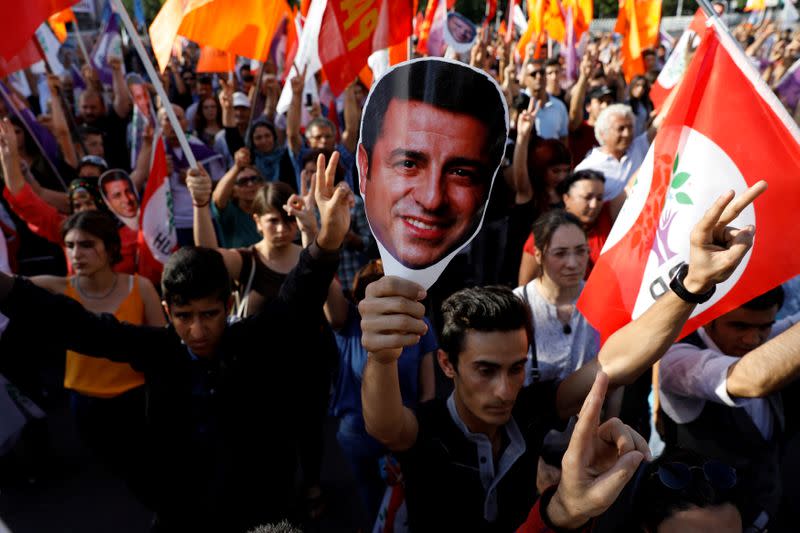 FILE PHOTO: Supporters of Turkey's main pro-Kurdish Peoples' Democratic Party hold masks of their jailed former leader and presidential candidate Selahattin Demirtas during a rally in Ankara