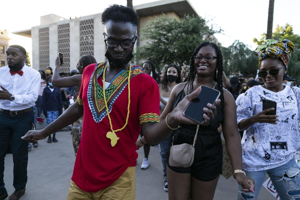 William Hej Santos, organizer for A March with Our Ancestors, dances in celebration of Juneteenth in Phoenix on June 19, 2020. Juneteenth, also known as Freedom Day, marks the anniversary of the day African Americans enslaved in Galveston, Texas, learned of their freedom.