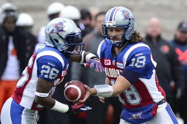 Montreal RB Chris Rainey (26. seen taking a handoff against B.C. Sunday) is one of at least four CFL players who have faced charges over allegations of domestic abuse. (Paul Chiasson/The Canadian Press.)