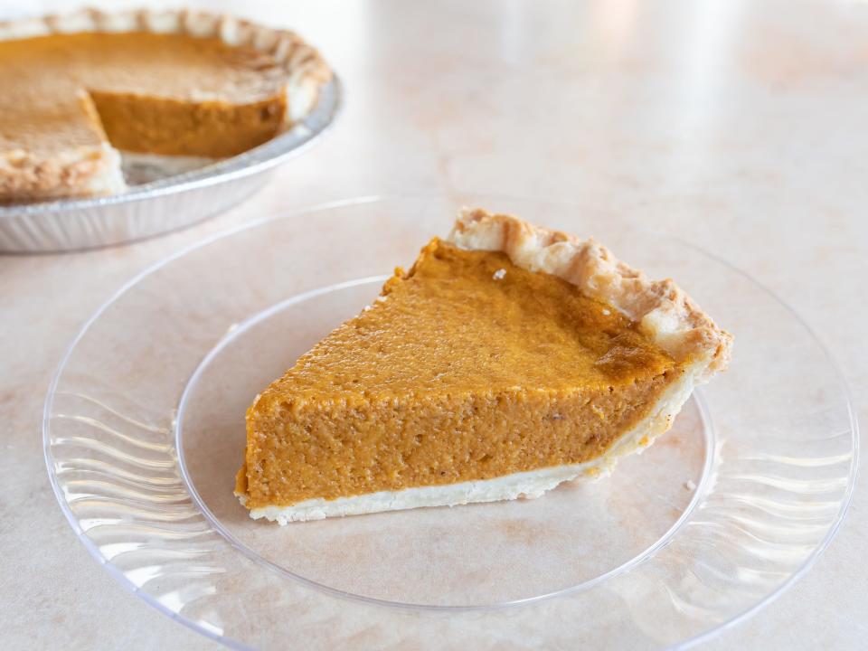 A slice of Kroger pumpkin pie on a clear pumpkin