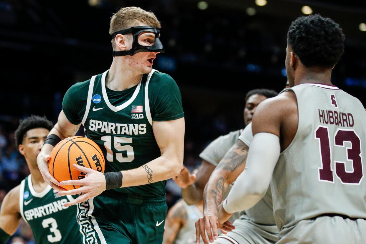 Michigan State center Carson Cooper (15) looks to pass against Mississippi State guard Josh Hubbard (13) during the second half of NCAA tournament West Region first round at Spectrum Center in Charlotte, N.C. on Thursday, March 21, 2024.