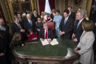 <p>President Donald Trump is joined by the Congressional leadership and his family as he formally signs his cabinet nominations into law, in the President’s Room of the Senate, at the Capitol in Washington,January 20, 2017. From left are Senate Minority Leader Chuck Schumer, D-N.Y., Sen. Roy Blunt, R-Mo., Donald Trump Jr., Vice President Mike Pence, Jared Kushner, Karen Pence, Ivanka Trump, Barron Trump, Melania Trump, Speaker of the House Paul Ryan, R-Wis., Majority Leader Kevin McCarthy, D-Calif., House Minority Leader Nancy Pelosi, D-Calif. (Photo: J. Scott Applewhite, Pool/AP) </p>