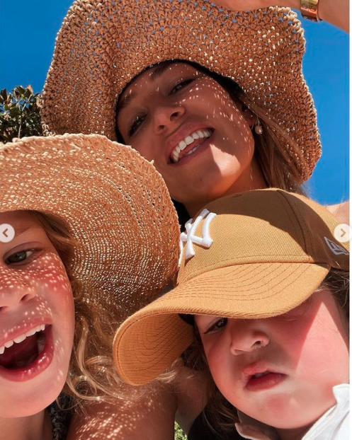 Phoebe Burgess and her children in the sun