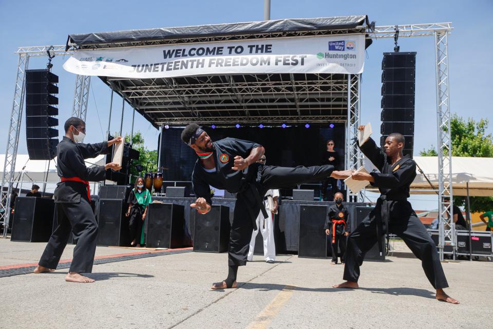 Devon Walsh, 30, center, from Alkebu-Do Martial Arts School performs at the Juneteenth Fest at the Eastern Market in Detroit on Sunday, June 19, 2022. 