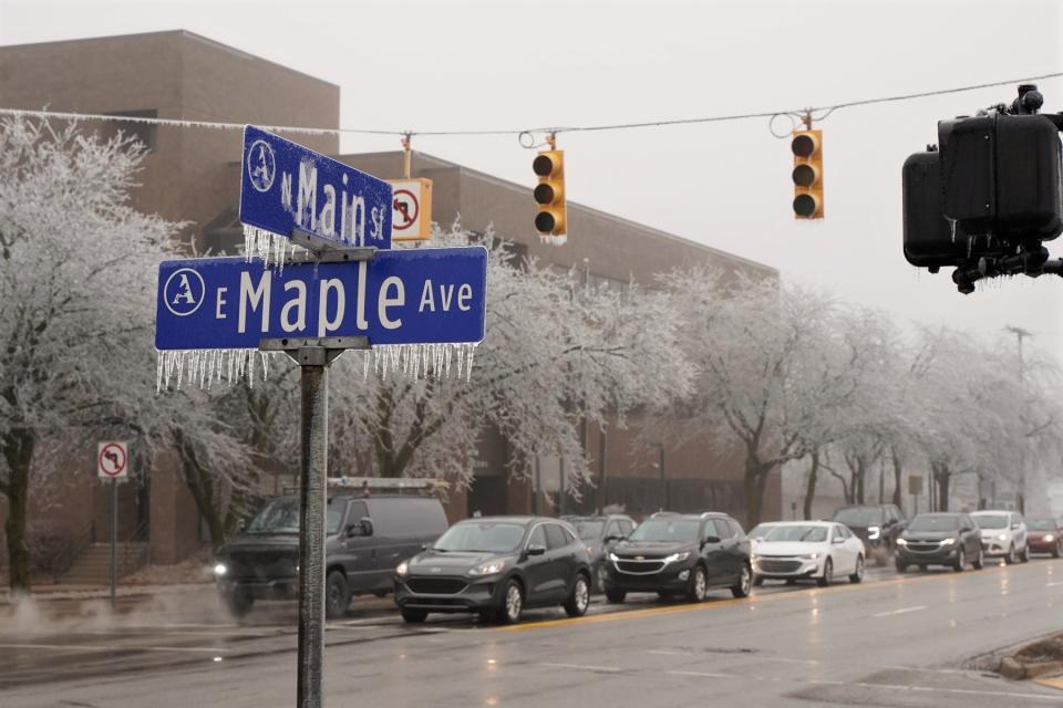 Road signs in downtown Adrian, like this one at the corner of East Maple Avenue and North Main Street were covered in ice Thursday morning, Feb. 23, 2023, after a freezing rain and ice storm moved through Lenawee County on Wednesday. Power was also out at this intersection, and motorists have been advised to treat such instances as a 4-way stop.