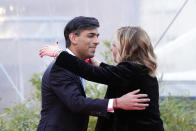 Italy's Prime Minister Giorgia Meloni hugs Britain's Prime Minister Rishi Sunak as he leaves the annual political festival Atreju, organized by the Giorgia Meloni's Brothers of Italy political party, in Rome, Saturday, Dec. 16, 2023. (AP Photo/Alessandra Tarantino)