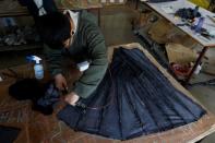 A man works at a mink fur clothing factory in Shangcun