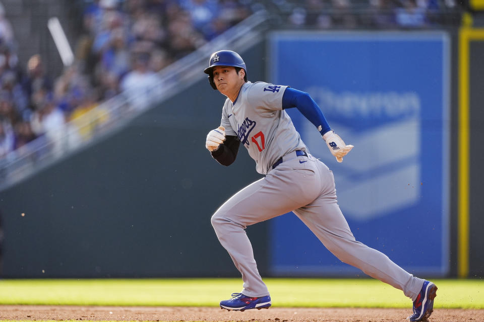 Los Angeles Dodgers' Shohei Ohtani takes off from second base to score on a single by Freddie Freeman off Colorado Rockies starting pitcher Ryan Feltner during the second inning of a baseball game Wednesday, June 19, 2024, in Denver. (AP Photo/David Zalubowski)
