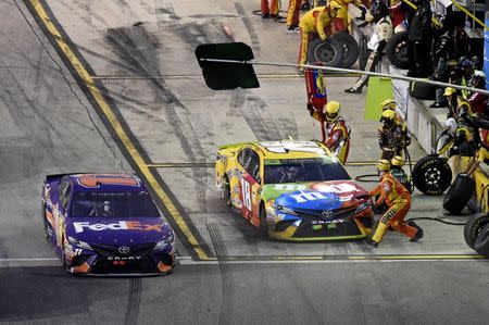 Nov 18, 2018; Homestead, FL, USA; NASCAR Cup Series driver Kyle Busch (18) makes a pit stop during the Ford EcoBoost 400 at Homestead-Miami Speedway. Mandatory Credit: John David Mercer-USA TODAY Sports