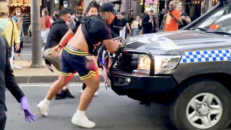 Cruz Topai-Aveai, pictured here grabbing the bullbar of the police car at the protest.