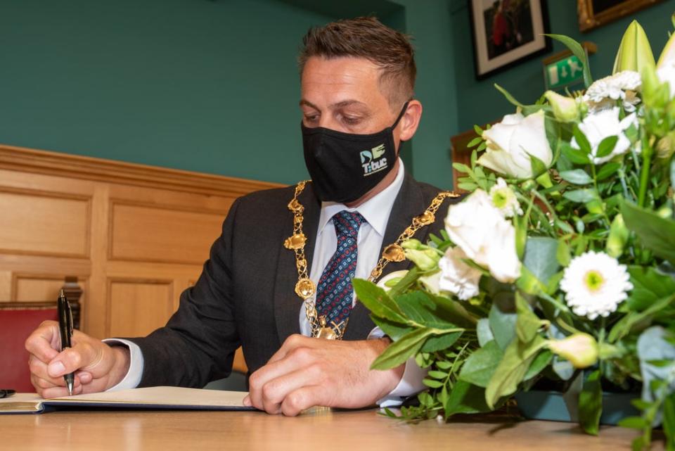 Handout photo issued by Derry and Strabane District Council of Derry City and Strabane District Council Mayor, Alderman Graham Warke, signing the Book of Condolence for Pat Hume in the Guildhall in Londonderry (PA) (PA Media)