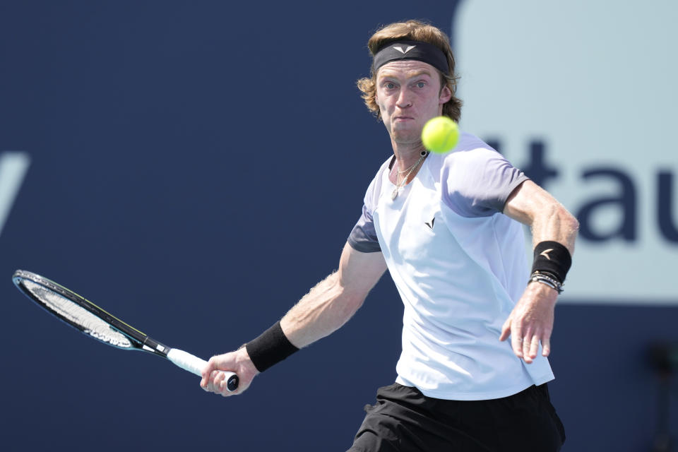 Andrey Rublev returns to Jannik Sinner of Italy during the Miami Open tennis tournament, Tuesday, March 28, 2023, in Miami Gardens, Fla. (AP Photo/Marta Lavandier)