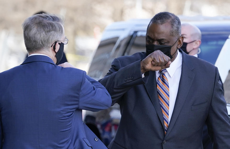 Defense Secretary Lloyd Austin, right, greets Deputy Secretary of Defense David Norquist as he arrives at the Pentagon, Friday, Jan. 22, 2021, in Washington. (AP Photo/Alex Brandon)