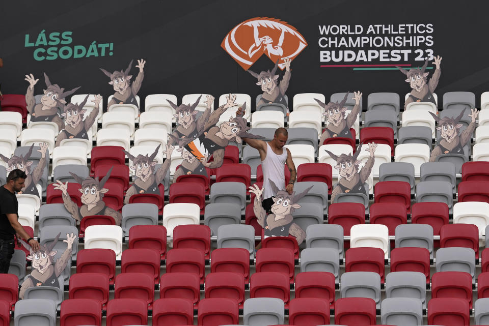 Workers place cutouts of the games mascot, Youhuu, a native Hungarian sheep, as preparations are made for the start of the World Athletics Championships in Budapest, Hungary, Thursday, Aug. 17, 2023. Budapest hosts the 19th edition of the Athletics Worlds between 19 and 27 of August. (AP Photo/Matthias Schrader)