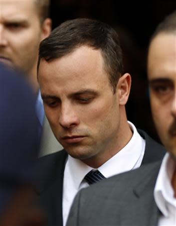 South African Olympic and Paralympic track star Oscar Pistorius (C) leaves after his trial at the high court in Pretoria April 8, 2014. REUTERS/Siphiwe Sibeko