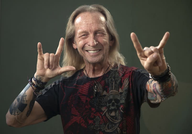 BURBANK, CA - JANUARY 15: Paul Raci, in the film "Sound of Metal," plays someone who helps the lead character adapt to his sudden deafness. Paul was born and raised by deaf parents and is fluent in American Sign Language. He signs "love," (left, with the thumb out) and the universal rock and roll sign of the horns as he is also a singer in a Black Sabbath tribute band. Photographed in Burbank on Friday, Jan. 15, 2021 in Burbank, CA. (Myung J. Chun / Los Angeles Times)