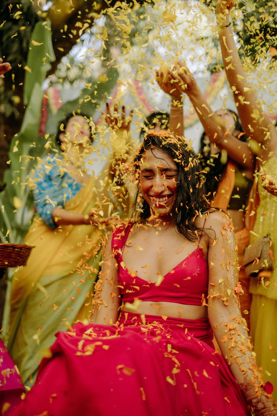 Mitali was showered with flower petals during the haldi ceremony, when the couple is typically painted with turmeric.