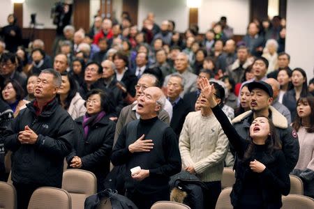 Participants pray for Canadian pastor Hyeon Soo Lim who is being held in North Korea during a joint multi-cultural prayer meeting at Light Korean Presbyterian Church in Toronto, December 20, 2015. REUTERS/Hyungwon Kang