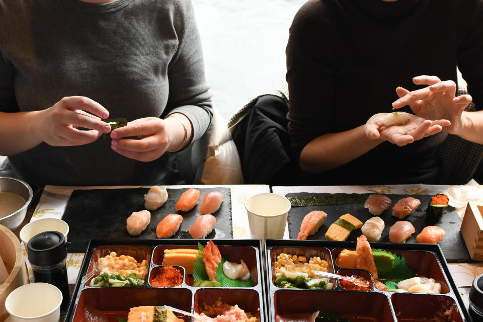 Foreign visitors learn how to make sushi in a cooking class at Sushi Making Tokyo in the Asakusa district of Tokyo, Japan, on Thursday, Dec. 28, 2023. (Photographer: Noriko Hayashi/Bloomberg)