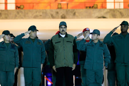 Venezuela's President Nicolas Maduro stands next to Venezuela's Defense Minister Vladimir Padrino Lopez and Remigio Ceballos, Strategic Operational Commander of the Bolivarian National Armed Forces, during a ceremony at a military base in Caracas, Venezuela May 2, 2019. Miraflores Palace/Handout via REUTERS