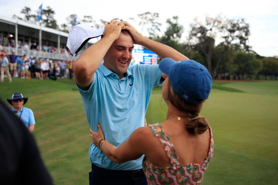 Scottie Scheffler reacts with his wife Meredith Scudder on hole 18 after winning the tournament during the fourth and final round of The Players golf tournament Sunday, March 12, 2023 at TPC Sawgrass in Ponte Vedra Beach, Fla. Scottie Scheffler of Dallas won the tournament at 17 under par with Tyrell Hatton at 12 under par as runner-up. 