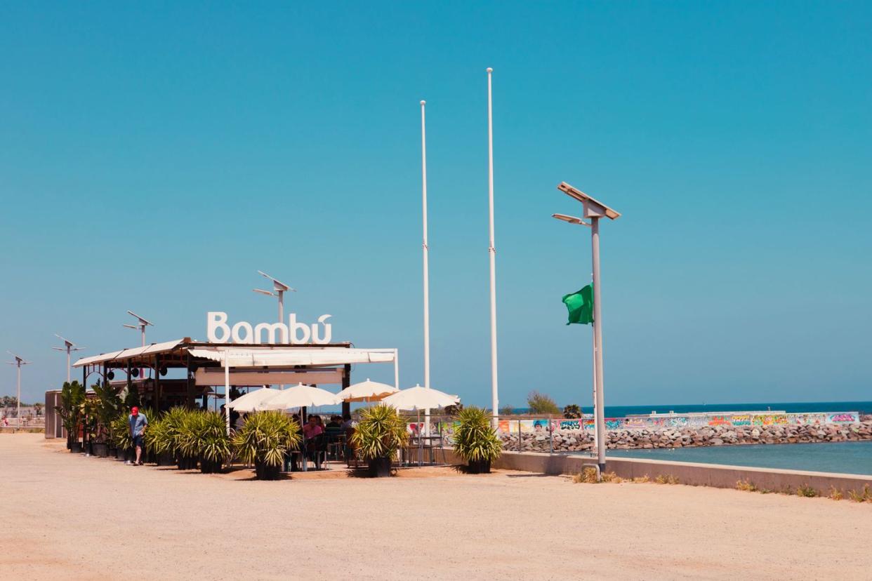 a beach with a sign and a flag