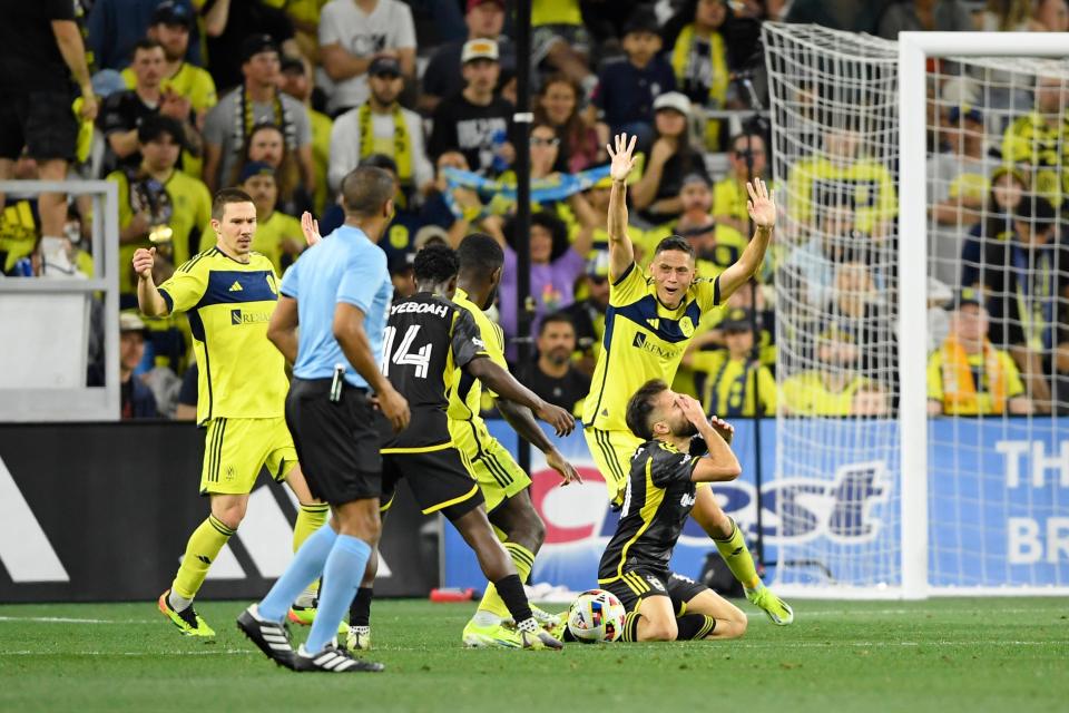 Crew forward Diego Rossi (10) and Nashville defender Daniel Lovitz (2) react after a play on Saturday.