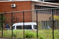 A police vehicle is seen inside the Belgium's National Institute of Criminology domain after arsonists set fire to it in Brussels, Belgium August 29, 2016. REUTERS/Eric Vidal