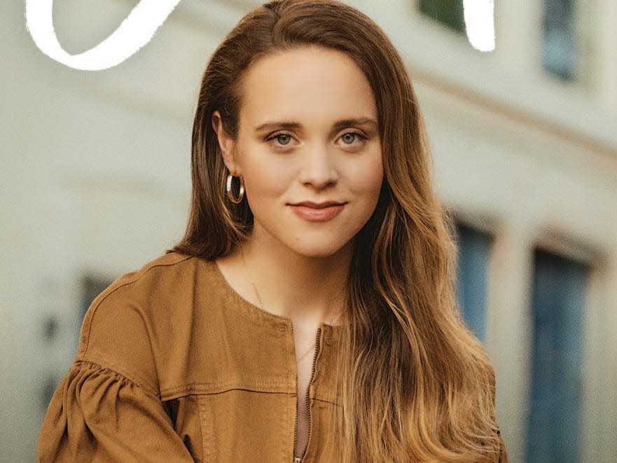 Jinger Duggar Vuolo smiling on her book's cover.