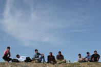 Afghan migrants rest near a bus terminal as they struggle to find buses to take them to western Turkish cities after crossing the Turkey-Iran border in Agri, eastern Turkey, April 11, 2018. Picture taken April 11, 2018. REUTERS/Umit Bektas