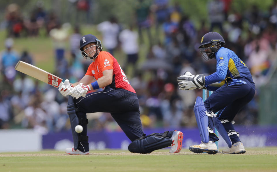 England's Joe Root plays a shot as Sri Lanka's wicketkeeper Niroshan Dickwella watches during their second one-day international cricket match in Dambulla, Sri Lanka, Saturday, Oct. 13, 2018. (AP Photo/Eranga Jayawardena)