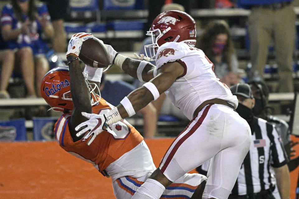 Florida wide receiver Justin Shorter, left, catches a pass in the end zone for a 21-yard touchdown in front of Arkansas defensive back Jalen Catalon during the first half of an NCAA college football game Saturday, Nov. 14, 2020, in Gainesville, Fla. (AP Photo/Phelan M. Ebenhack)