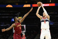 Washington Wizards center Kristaps Porzingis (6) looks to shoot against Cleveland Cavaliers forward Evan Mobley (4) during the first half of an NBA basketball game, Monday, Feb. 6, 2023, in Washington. (AP Photo/Nick Wass)