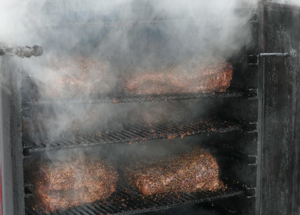Beef brisket, which will take nine hours to cook, is seen in the smoker at Big Eu'es BBQ on Portage Trail in Cuyahoga Falls on Thursday Feb. 18, 2021.