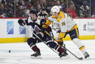 Colorado Avalanche left wing Jonathan Drouin, ledft, and Nashville Predators left wing Cole Smith pursue the puck in the second period of an NHL hockey game Saturday, March 30, 2024, in Denver. (AP Photo/David Zalubowski)