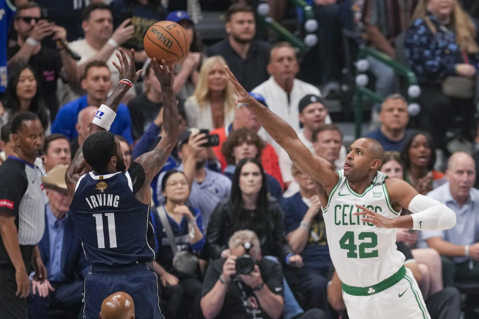 Dallas Mavericks guard Kyrie Irving shoots against Boston Celtics center Al Horford during the first half in Game 3 of the NBA basketball finals, Wednesday, June 12, 2024, in Dallas. (AP Photo/Sam Hodde)