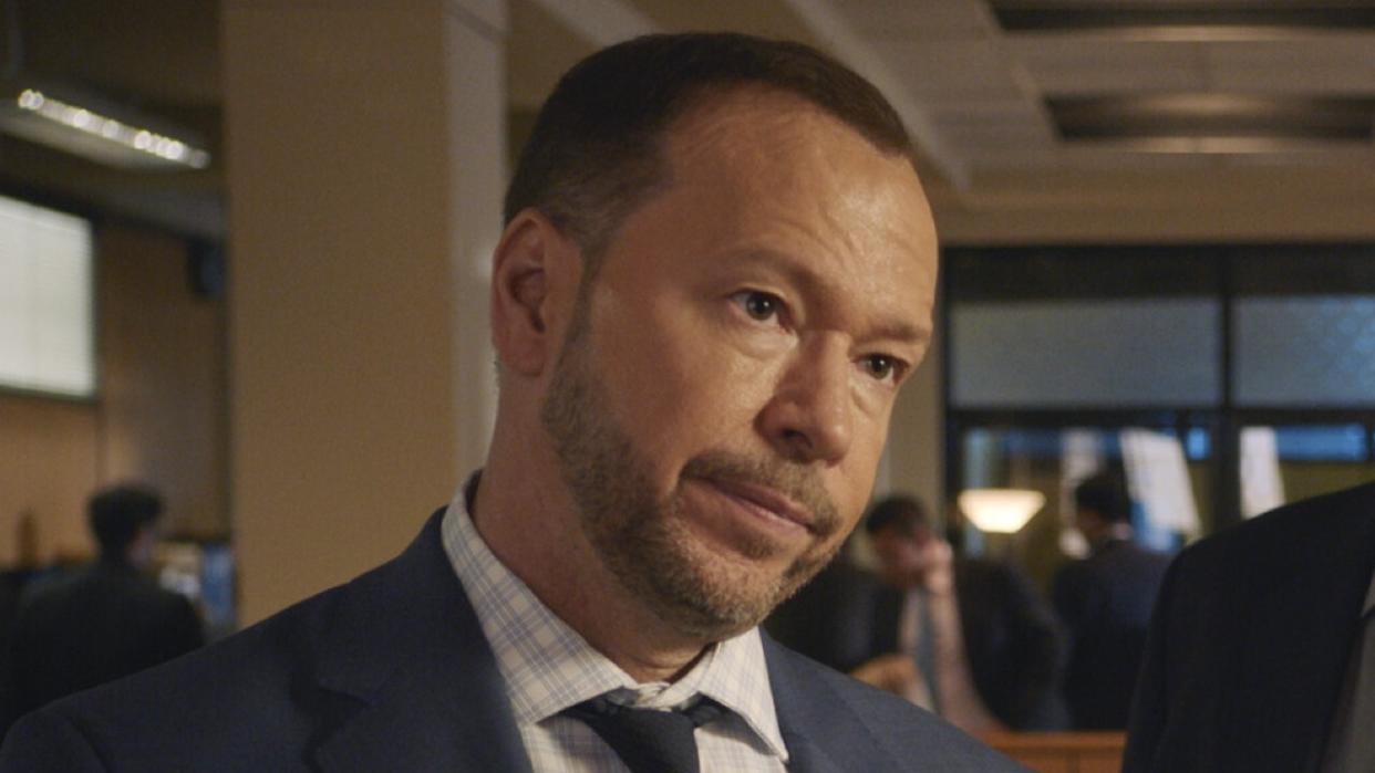  Donnie wahlberg looking concerned in a suit on Blue Bloods. 