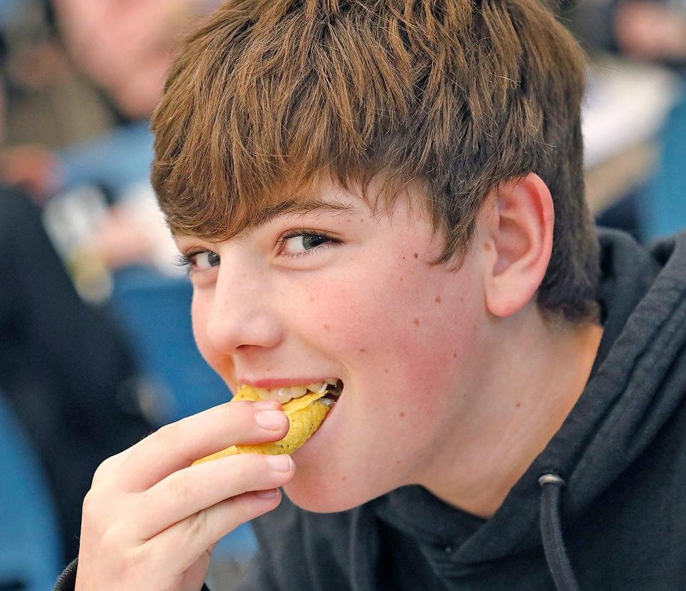 Gates Middle School seventh-grader Mark McGourty, 13, takes a bite of a fish taco on Thursday, Jan. 12, 2023.