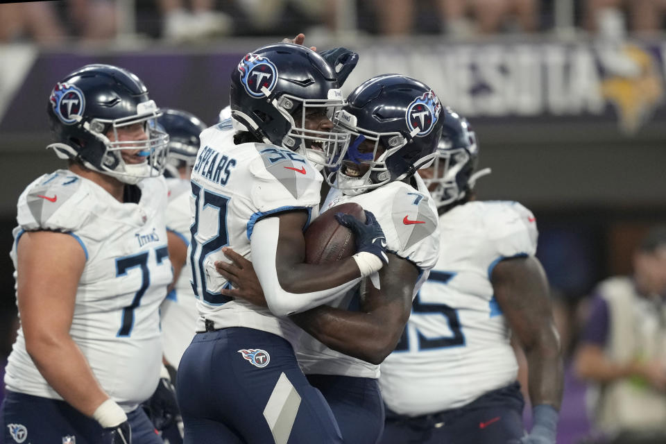 Tennessee Titans running back Tyjae Spears (32) and quarterback Malik Willis, center right, celebrate after Spears rushed for a touchdown in the first half of a preseason NFL football game against the Minnesota Vikings, Saturday, Aug. 19, 2023, in Minneapolis. (AP Photo/Charlie Neibergall)