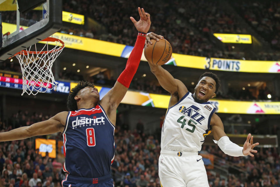 Utah Jazz guard Donovan Mitchell (45) pulls down a rebound as Washington Wizards forward Rui Hachimura (8) defends in the second half during an NBA basketball game Friday, Feb. 28, 2020, in Salt Lake City. (AP Photo/Rick Bowmer)