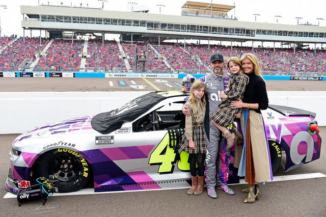 <p>Jared C. Tilton/Getty</p> Jimmie Johnson, his wife and daughters at a race in Arizona in 2020