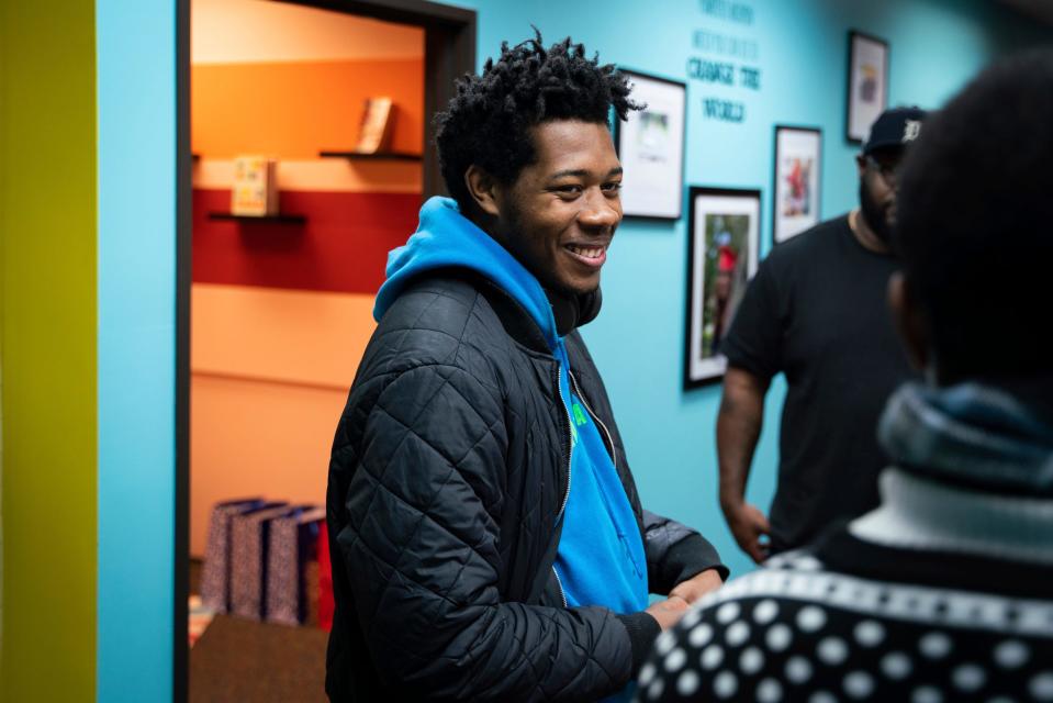 James Ashley, 24, of Detroit, talks with a youth volunteer at the Detroit Phoenix Center, an organization that provides support for youth facing economic, social, and educational challenges, in Detroit on Dec. 13, 2022.