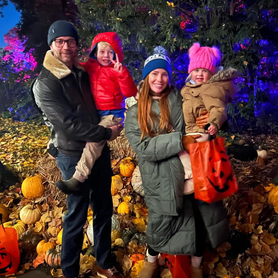 Mina Starsiak Hawk poses with husband Steve while holding kids Jack and Charlotte