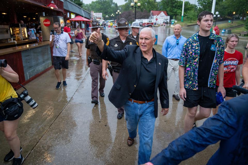 Former Vice President Mike Pence waves to patrons in the Bud Tent during a visit to the Iowa State Fair, Friday, Aug. 19, 2022.