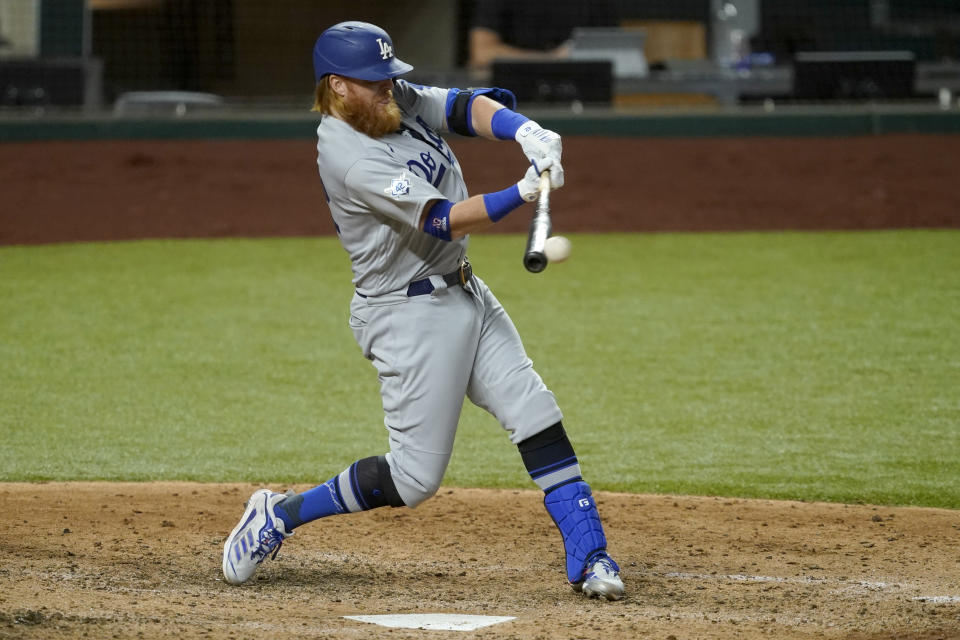 Los Angeles Dodgers' Justin Turner connects for a run-scoring single to left in the seventh inning of a baseball game against the Texas Rangers in Arlington, Texas, Friday, Aug. 28, 2020. The hit scored Corey Seager. (AP Photo/Tony Gutierrez)