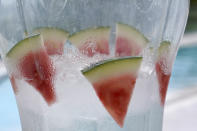 Watermelon slices sit in a pitcher of ice water at a poolside cafe at the 1 Hotel South Beach, Monday, Nov. 15, 2021, in Miami Beach, Fla. Cooped-up tourists eager for a taste of Florida's sandy beaches, swaying palm trees and warmer climates are visiting the Sunshine State in droves, topping pre-pandemic levels in recent months. (AP Photo/Lynne Sladky)