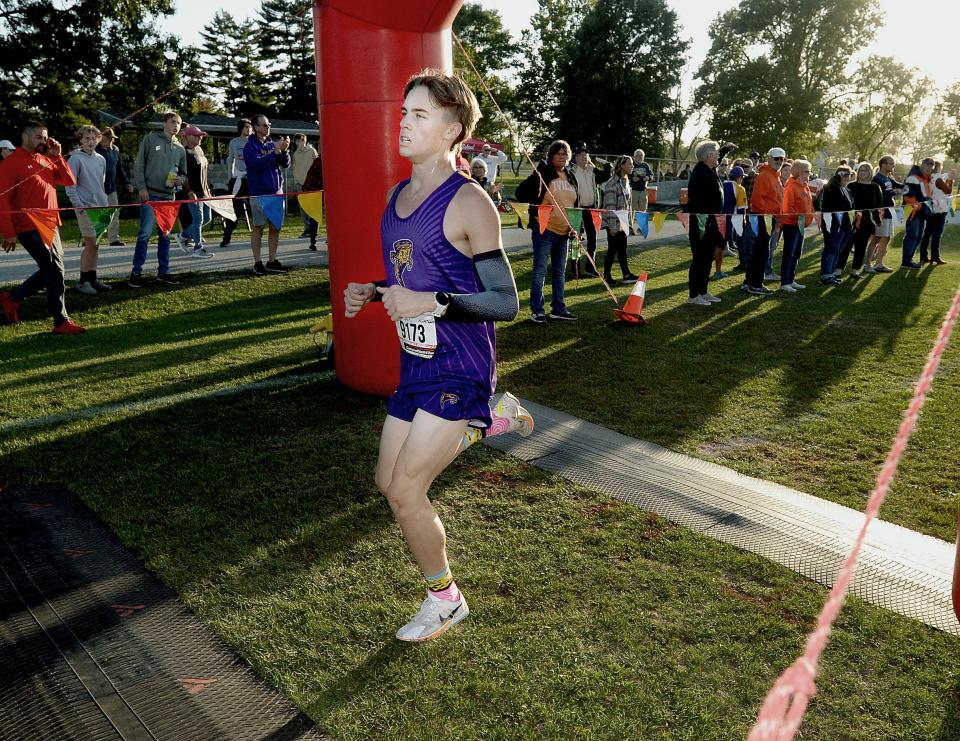 Taylorville's Liam Bettis crosses the finish line during a cross country meet Tuesday, Oct. 11, 2023.