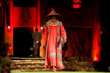 A model walks on a catwalk during a fashion show featuring African fashion and culture as part of a gala marking the launch of a book called "African Twilight: The Vanishing Rituals and Ceremonies of the African Continent" at the African Heritage House in Nairobi, Kenya March 3, 2019. REUTERS/Baz Ratner