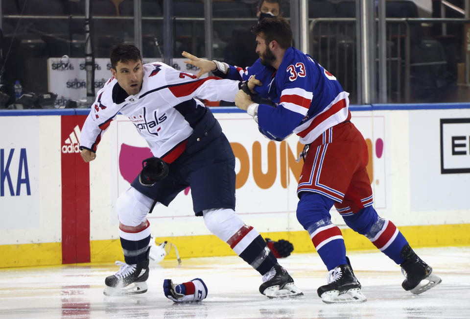 Washington Capitals' Garnet Hathaway (21) fights with New York Rangers' Phillip Di Giuseppe (33) during the first period of an NHL hockey game Wednesday, May 5, 2021, in New York. (Bruce Bennett/Pool Photo via AP)