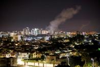 FILE PHOTO: Smoke rises over houses in Ashkelon following a rocket attack launched from Gaza towards Ashkelon, southern Israel